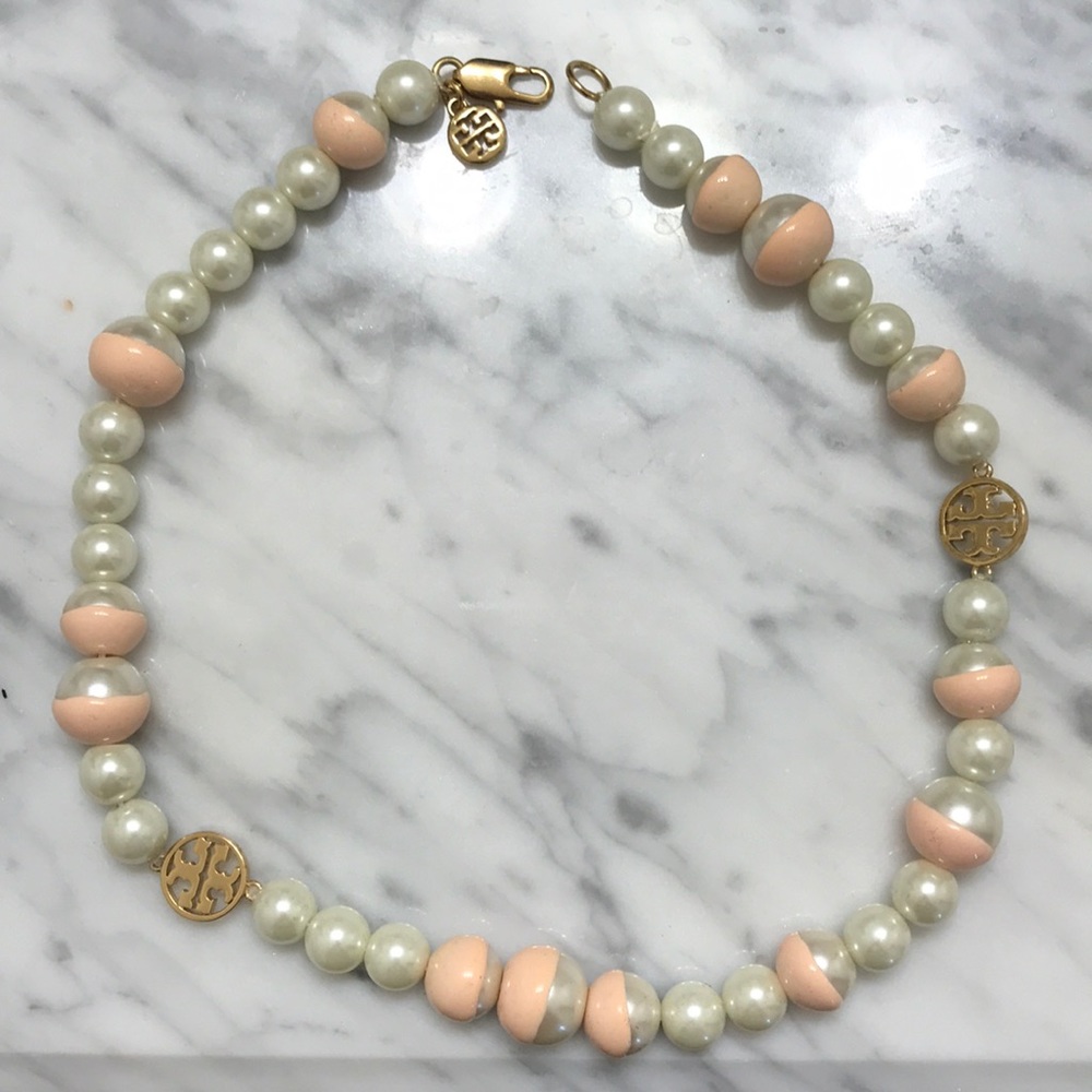 White/pink pearl necklace with gold accents.
